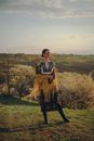 Woman in Folk Costume Standing in Field