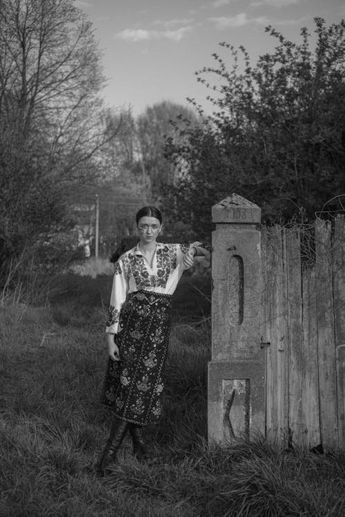 Grayscale Photo of Woman Posing at the Camera