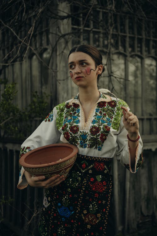 A Woman Holding a Clay Pot