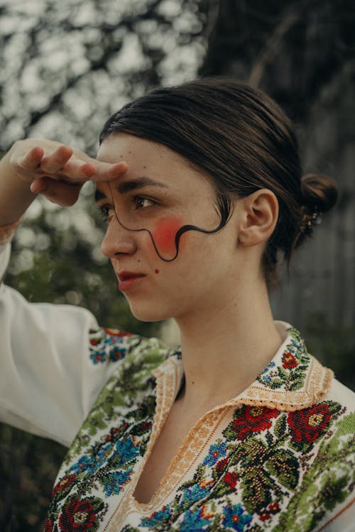 A Woman in White Green and Red Floral Shirt