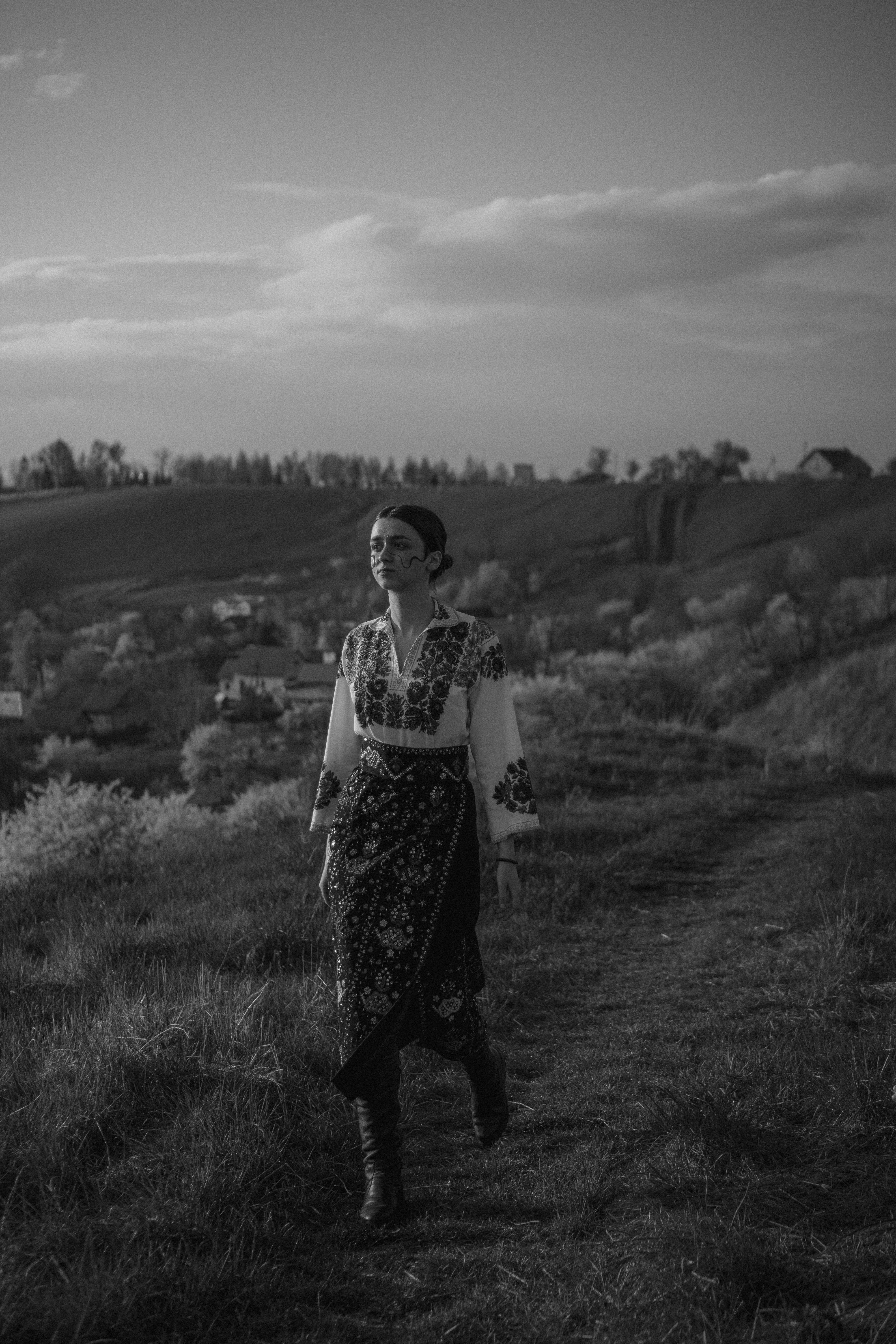 Grayscale Photo of Woman Walking on the Grass Field · Free Stock Photo