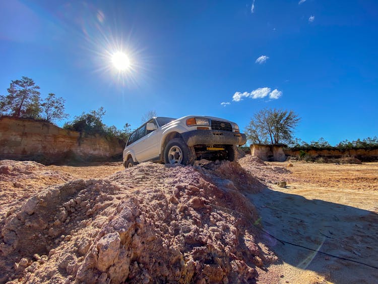 A Toyota Land Cruiser Driving On Pile Of Dirt