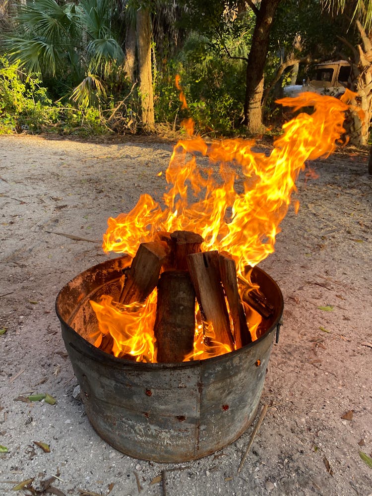 Burning Firewood On Metal Container