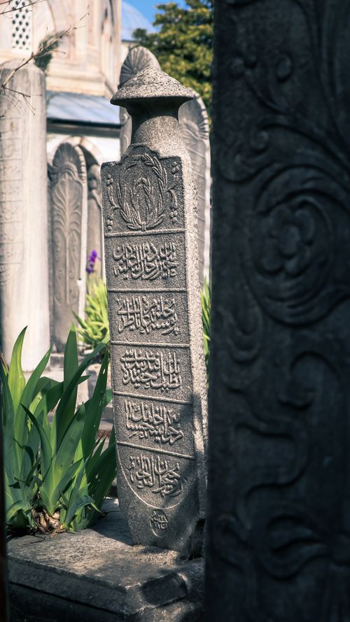 Free A historical tombstone with ornate engravings in an Istanbul cemetery, showcasing Ottoman architecture. Stock Photo