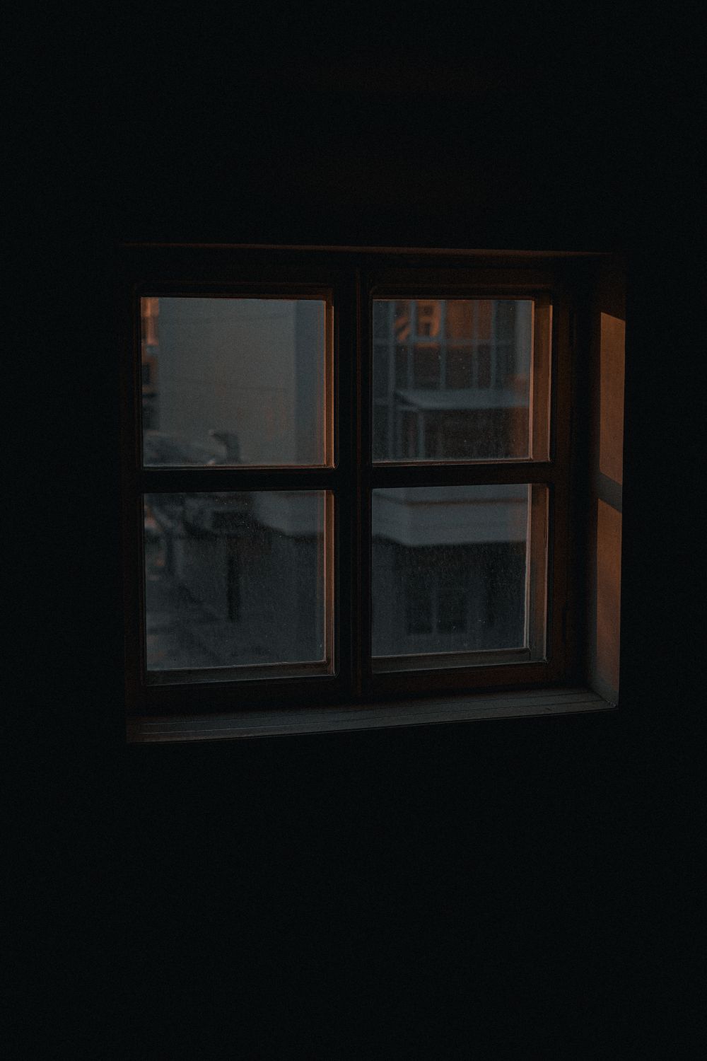 A single window holding the last of the daylight in a dim room