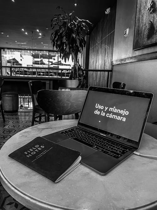Free Grayscale Photo of a Laptop on the Table Stock Photo