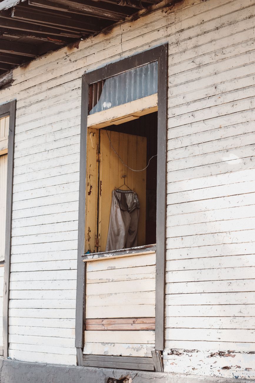 Photo by Luis Quintero Close-up of a weathered wooden window on a vintage house. Captures rustic charm and decay.