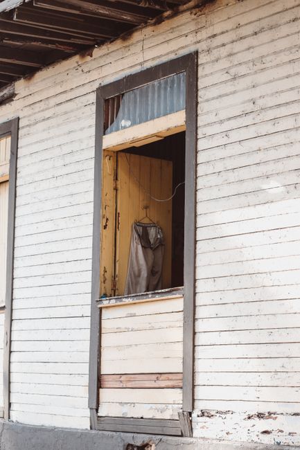 Photo by Luis Quintero Close-up of a weathered wooden window on a vintage house. Captures rustic charm and decay.