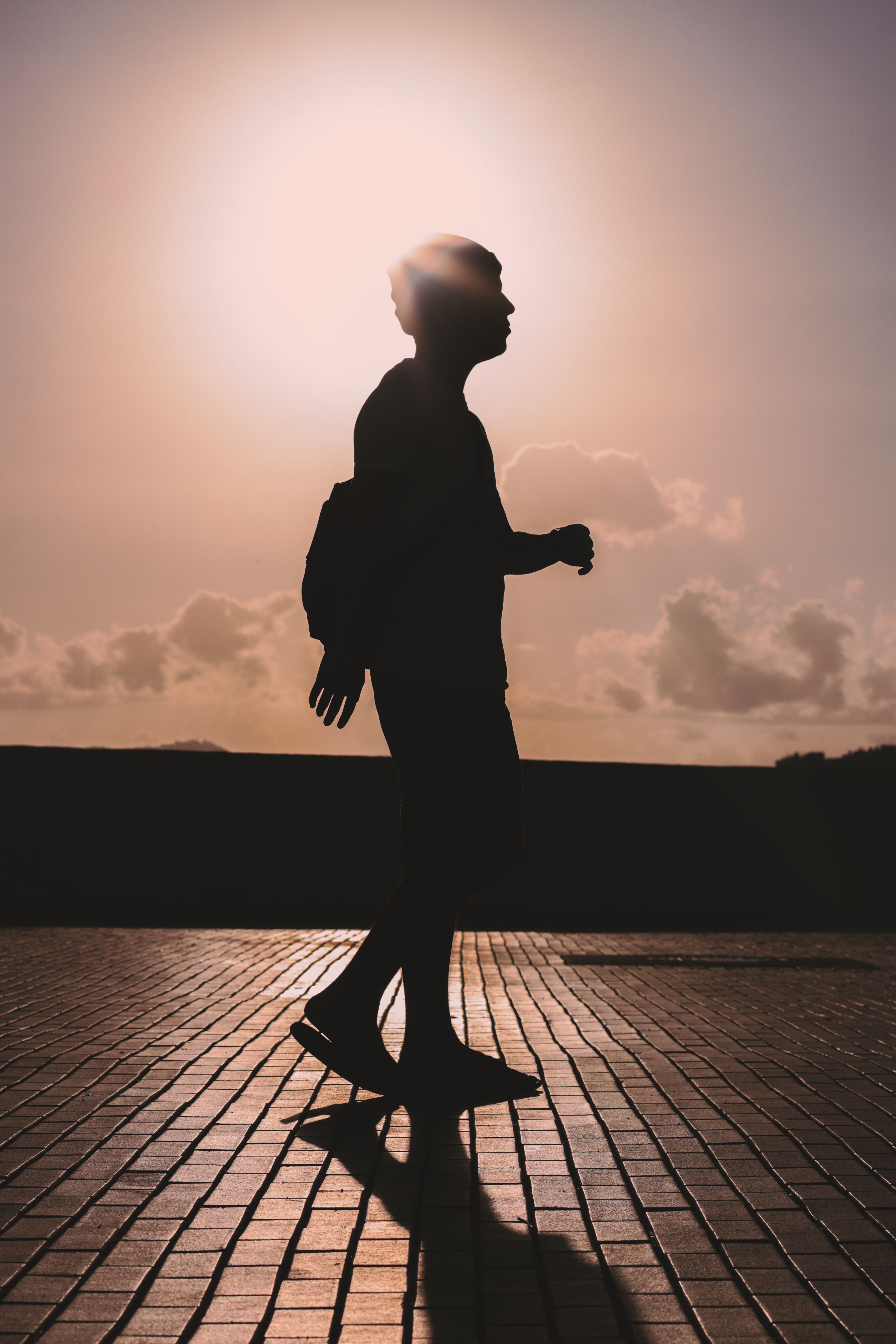 Silhouette of Man Walking on the Street · Free Stock Photo