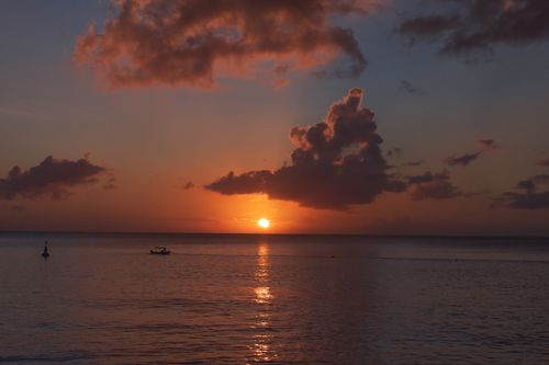 Free Sunset view over the ocean in Grenada, featuring a peaceful seascape. Stock Photo