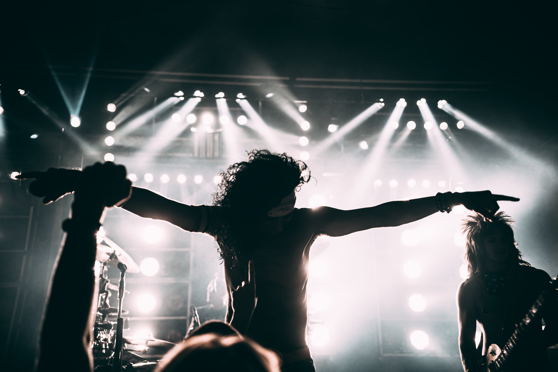 Craig and the Good Times Gang performing live, silhouettes against stage lights