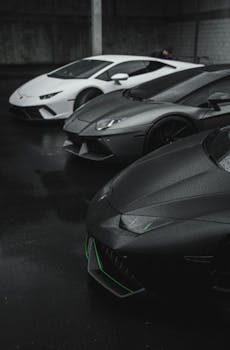 A trio of luxury Lamborghinis parked in a dimly lit garage, showcasing elegance and style.