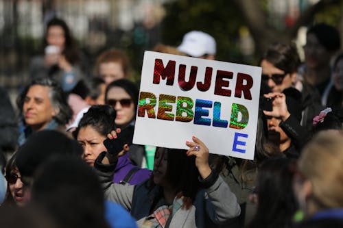 Woman holding a White Placard 