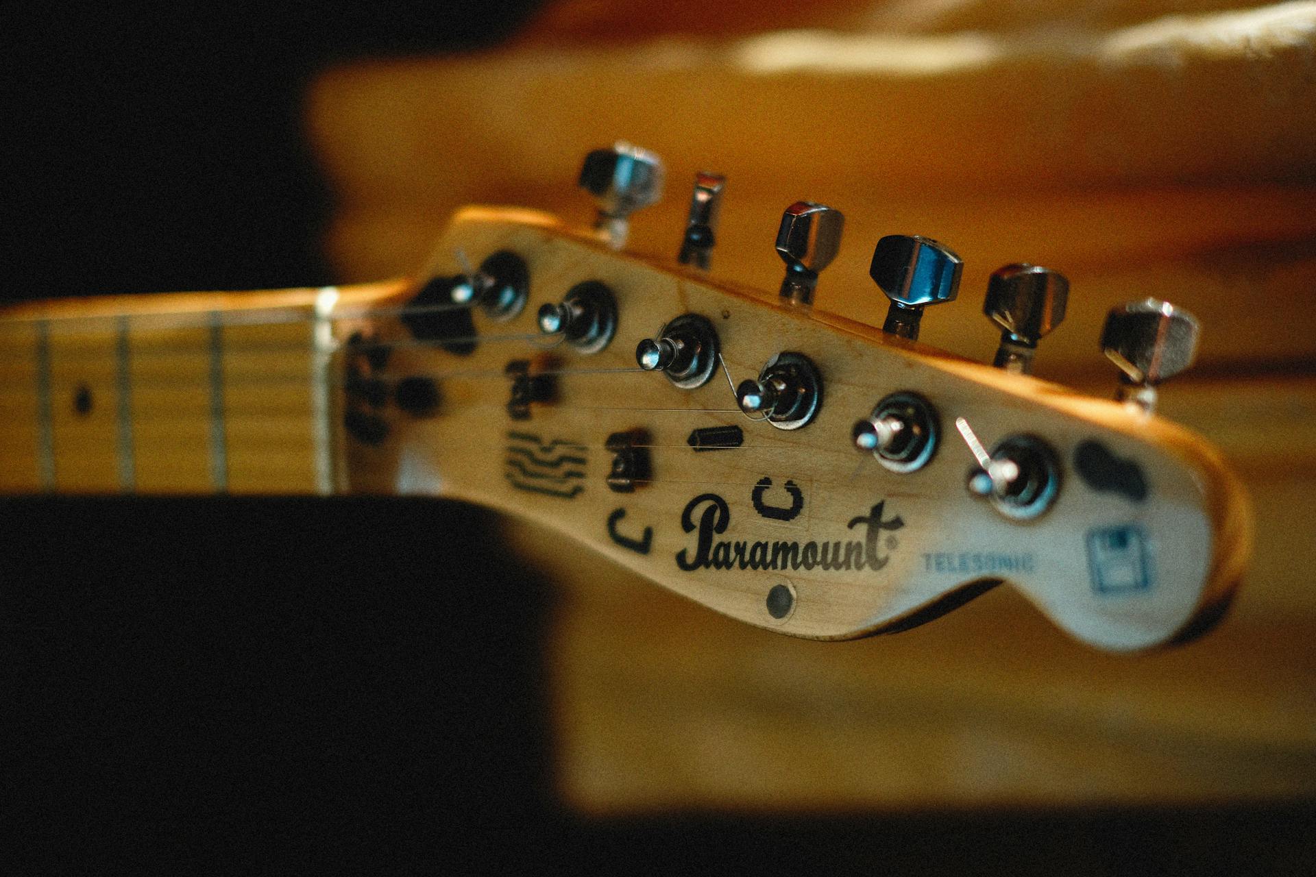 Detailed view of a Paramount electric guitar headstock with tuning pegs.