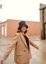 Woman in Tan Coat and Bucket Hat