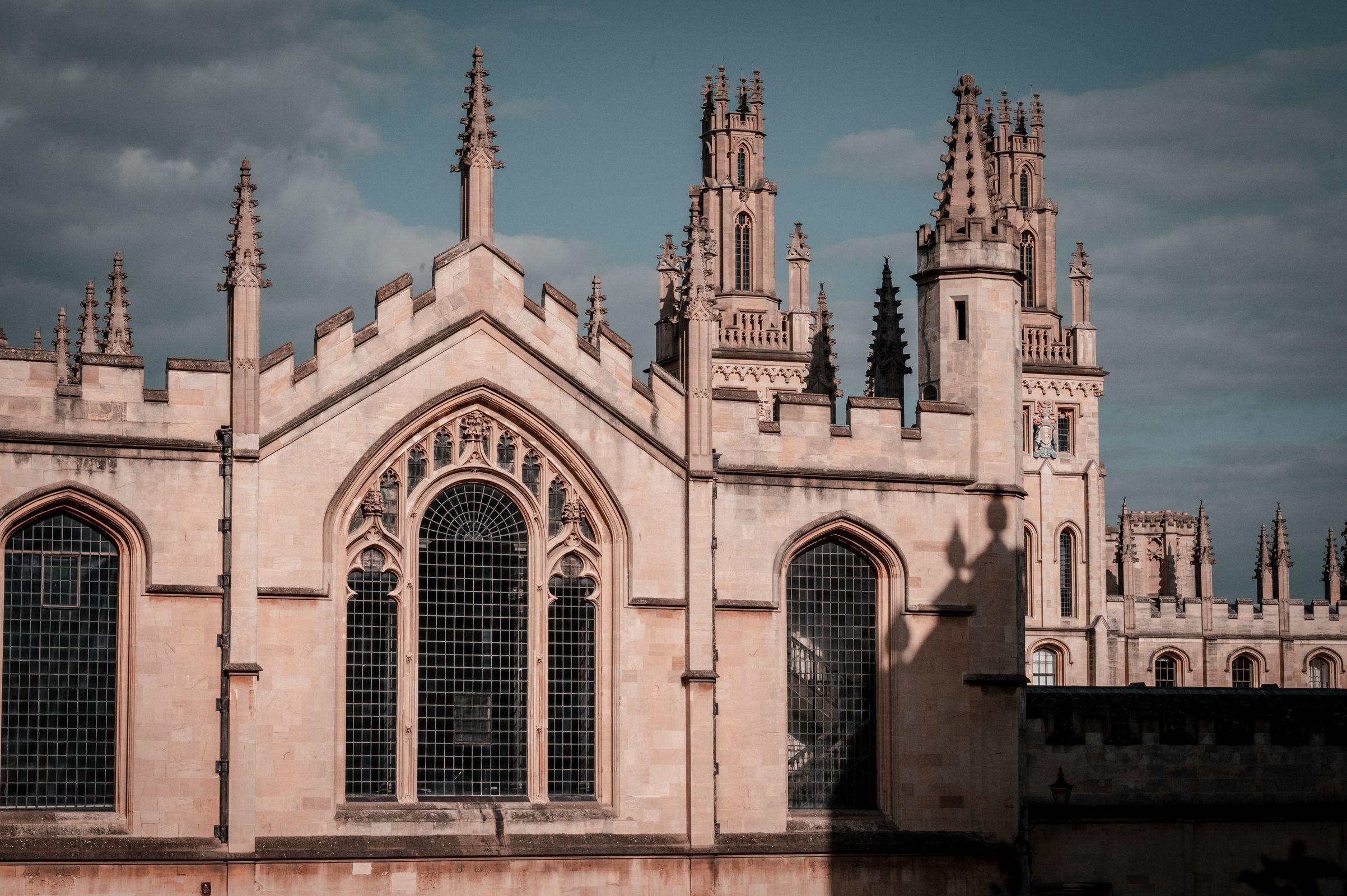 The spires of All Souls College, Oxford, against an evening sky