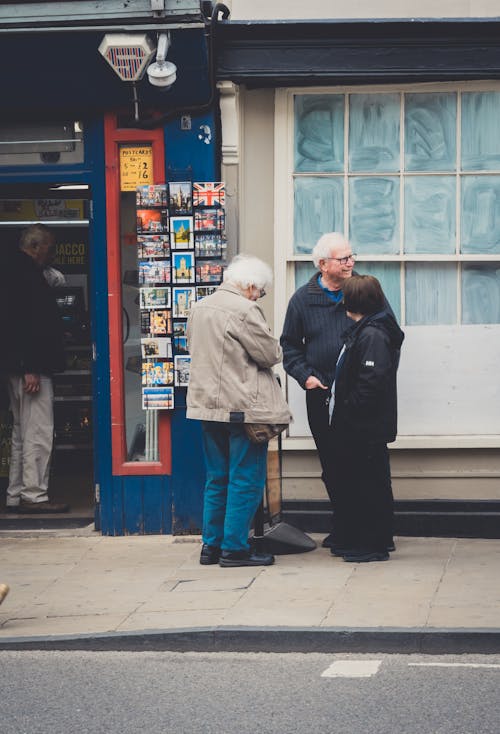 Elderly People Standing Together at the Sidewalk