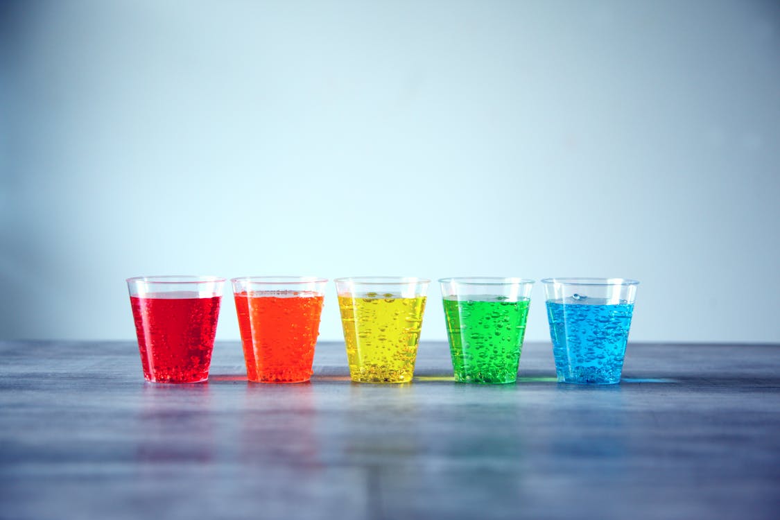 Five Assorted-color Rock's Glasses on Gray Surface