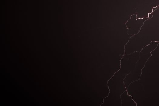 Captivating view of a lightning bolt illuminating the night sky during a thunderstorm.
