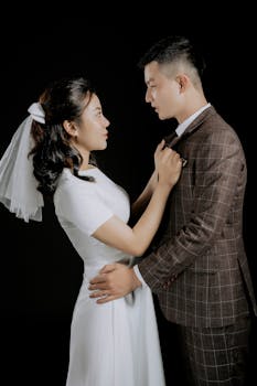 A romantic portrait of a bride and groom in formal attire on their wedding day.
