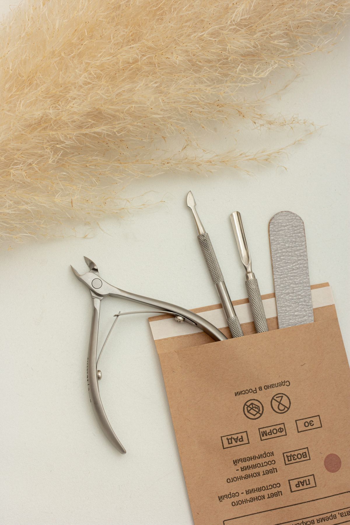 Premium manicure tools arranged on a soft neutral surface
