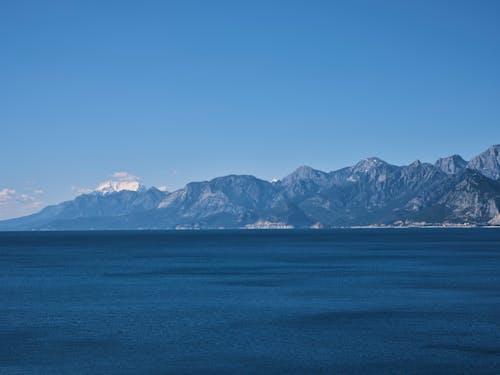 Free Mountains and Blue Seascape Under Blue Sky Scenery Stock Photo