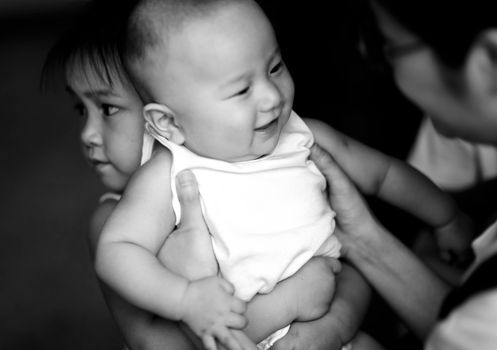 Adorable siblings captured in a candid family moment, showcasing love and joy.