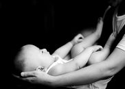 Black and White Photo of Baby Held by Parent