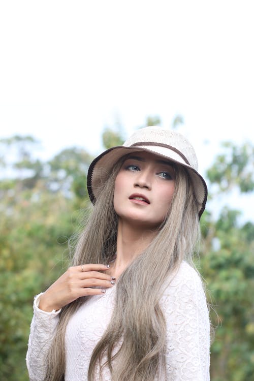 Woman in Lace Long Sleeve Top Wearing a Bucket Hat