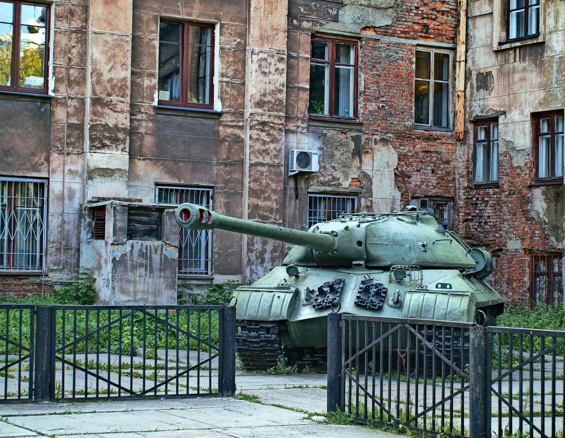 Green Battle Tank Beside the Brick Building