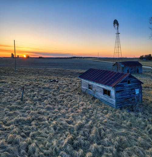 Free Wooden Houses on a Farmland at Sunset Stock Photo