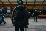Person in Black Jacket and Black Pants Walking on Sidewalk