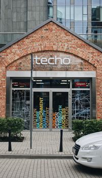 Chic Techo storefront in a brick building facade at Warsaw's business district, Poland.