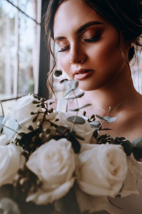 Bouquet of Flowers Near a Woman's Face · Free Stock Photo