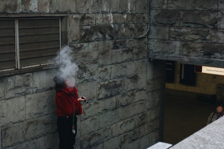 A Woman Vaping On The Street