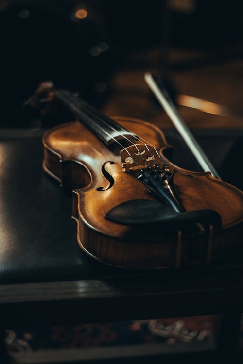 Free Brown Violin on Black Leather Textile Stock Photo