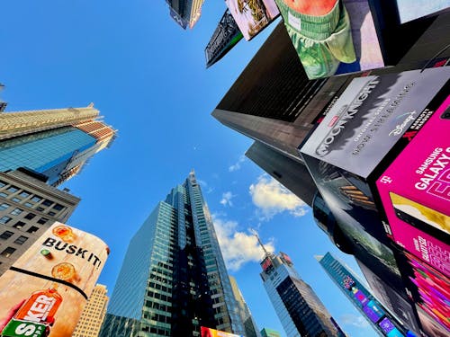 High Rise Buildings with Billboards in Low Angle Photography