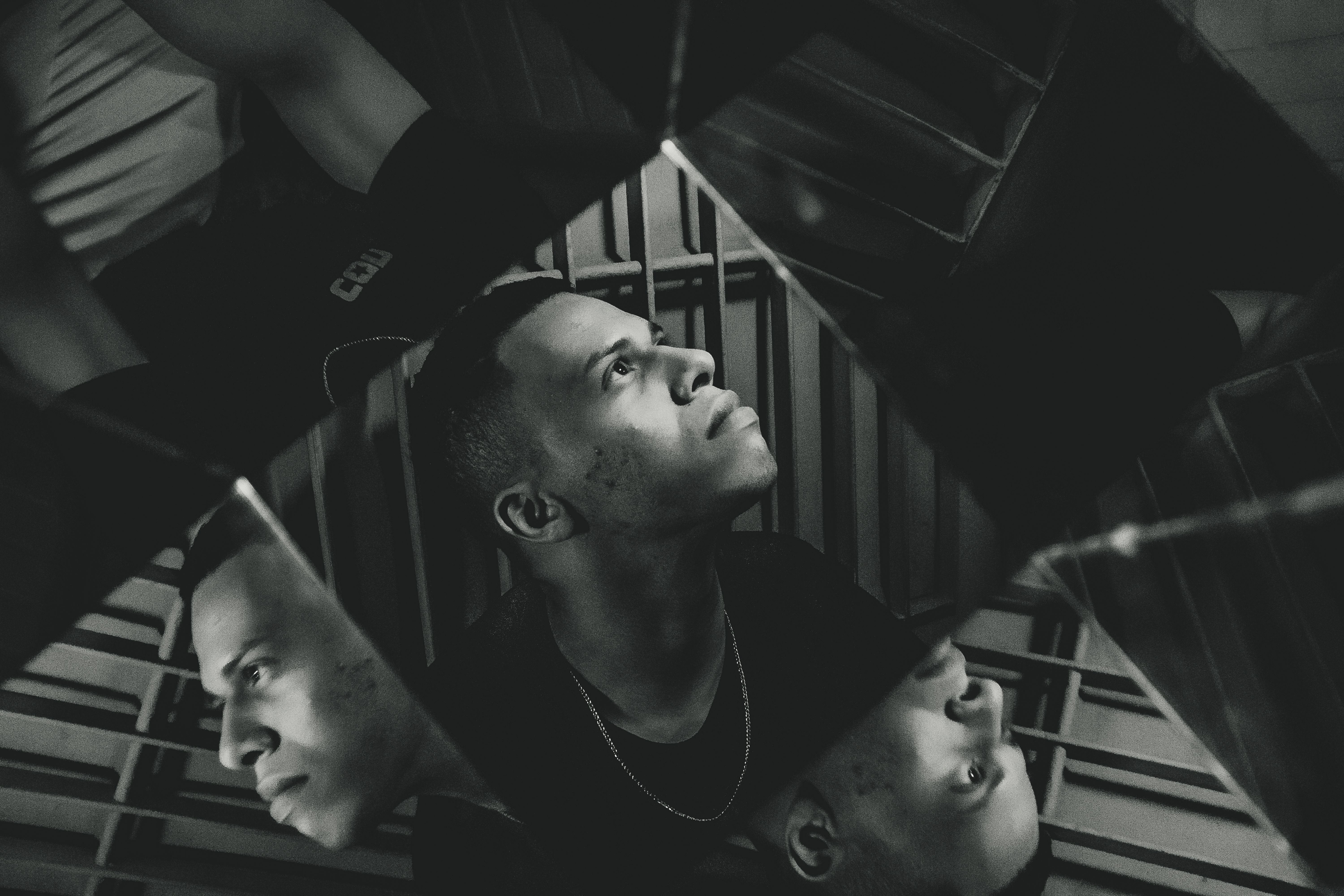 Black-and-white portrait of a man, artfully mirrored for a reflective effect