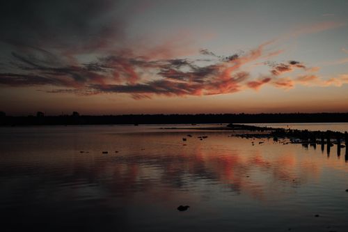 Free A breathtaking sunset over the lake in Odessa, Ukraine, with vivid colors and serene reflections. Stock Photo