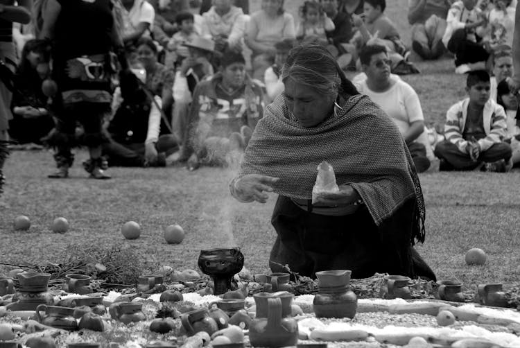 A Woman Kneeling On The Grass