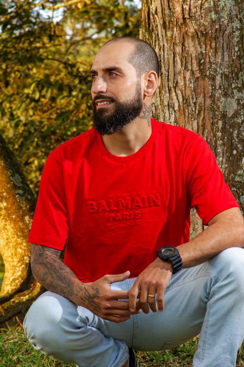 Bearded Man in Red Shirt Crouching