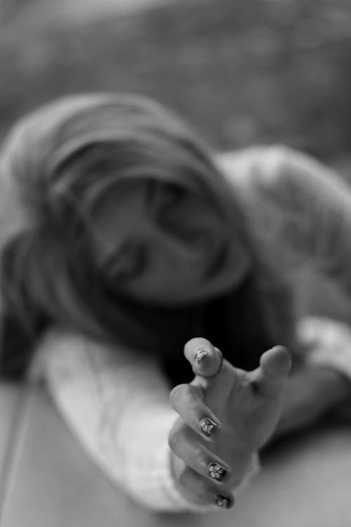 Black and White Photo of a Woman Reaching Out
