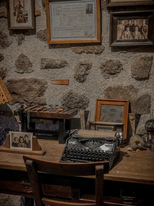Black Typewriter on Brown Wooden Table