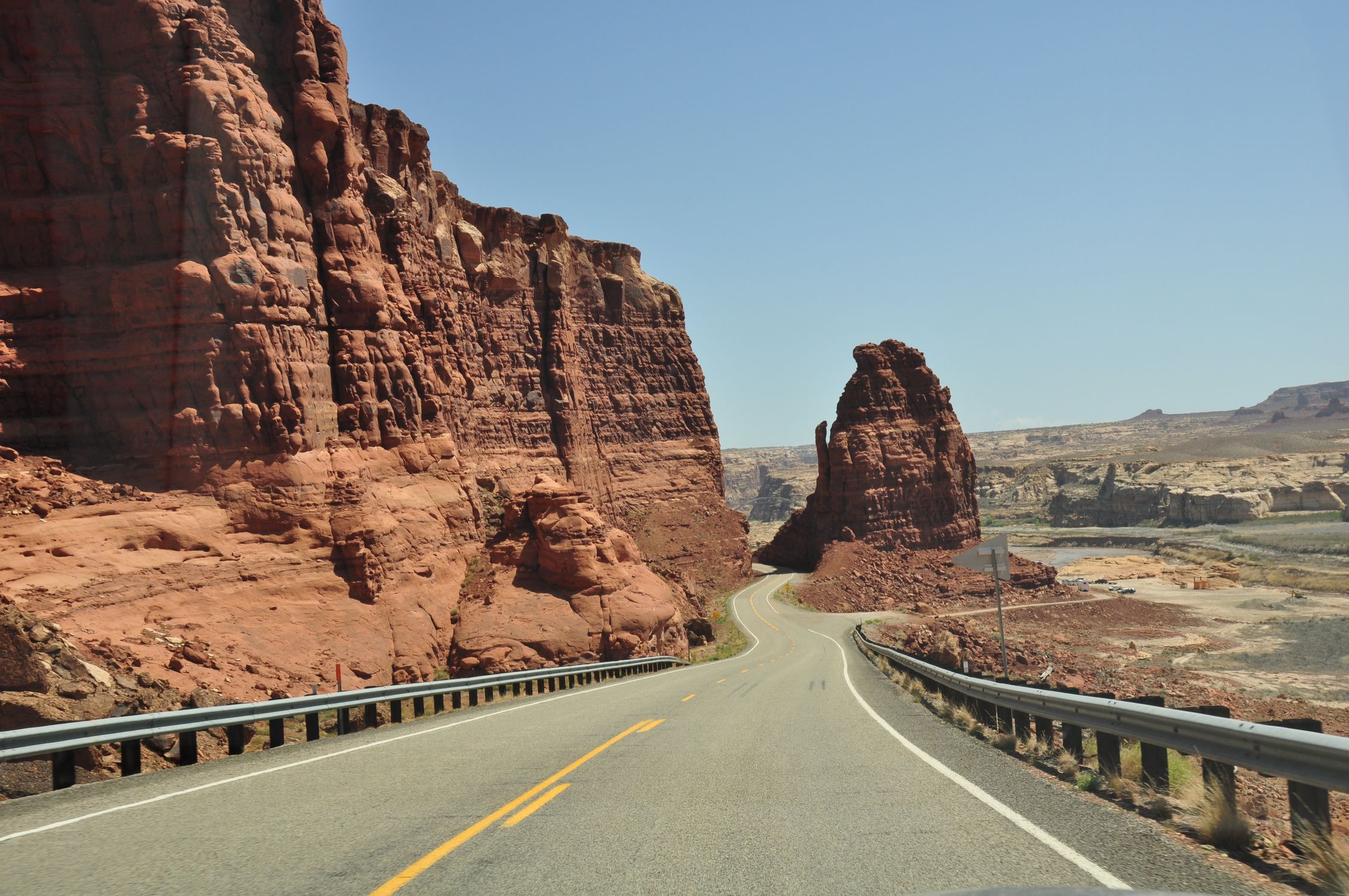 Explore the winding roads and majestic red rock formations of Utah's stunning desert scenery.