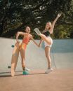 2 Women in Orange and White Bikini Playing Basketball
