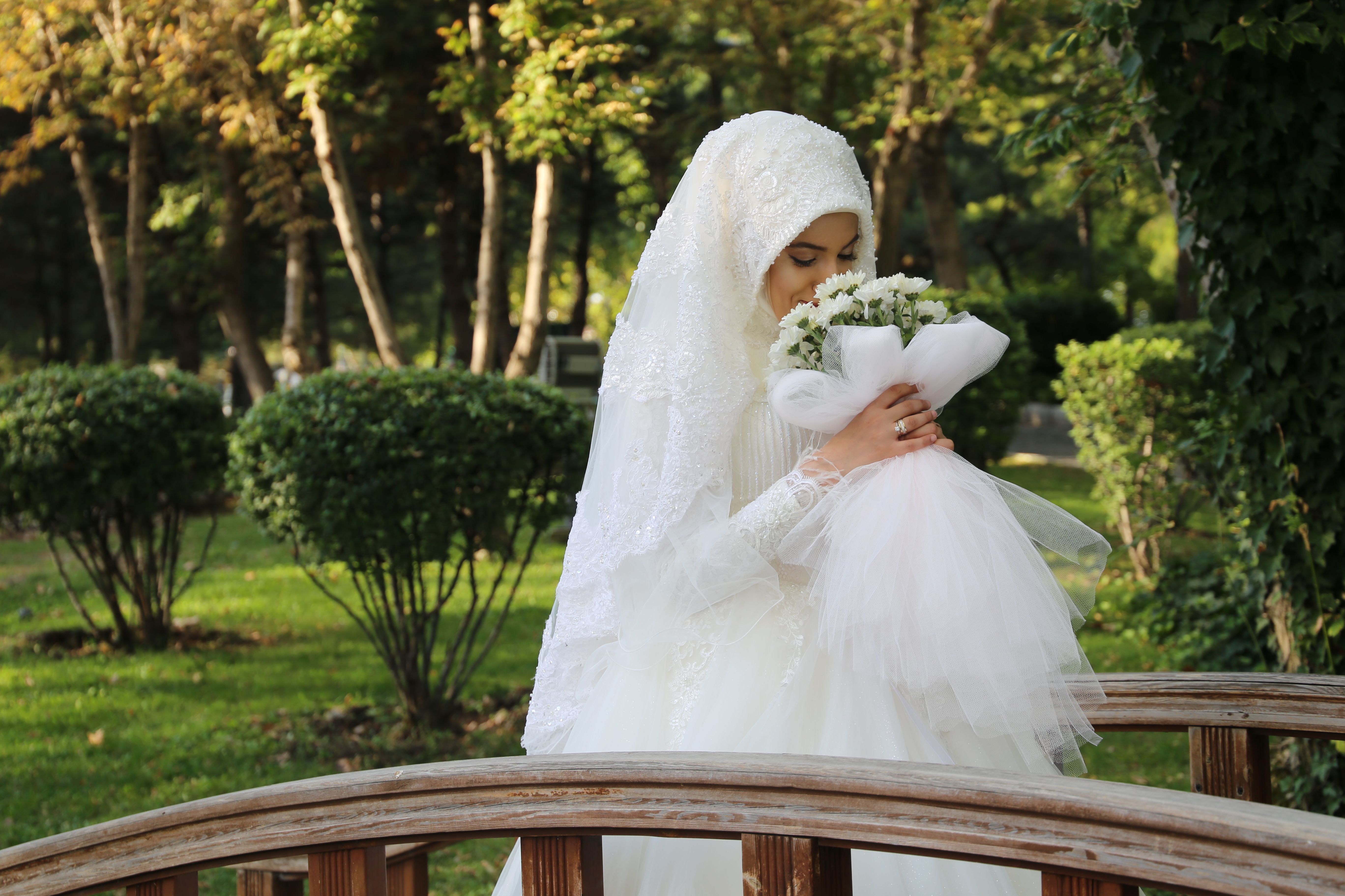 Woman in White Wedding Gown Holding a Bouquet of White Flowers · Free ...
