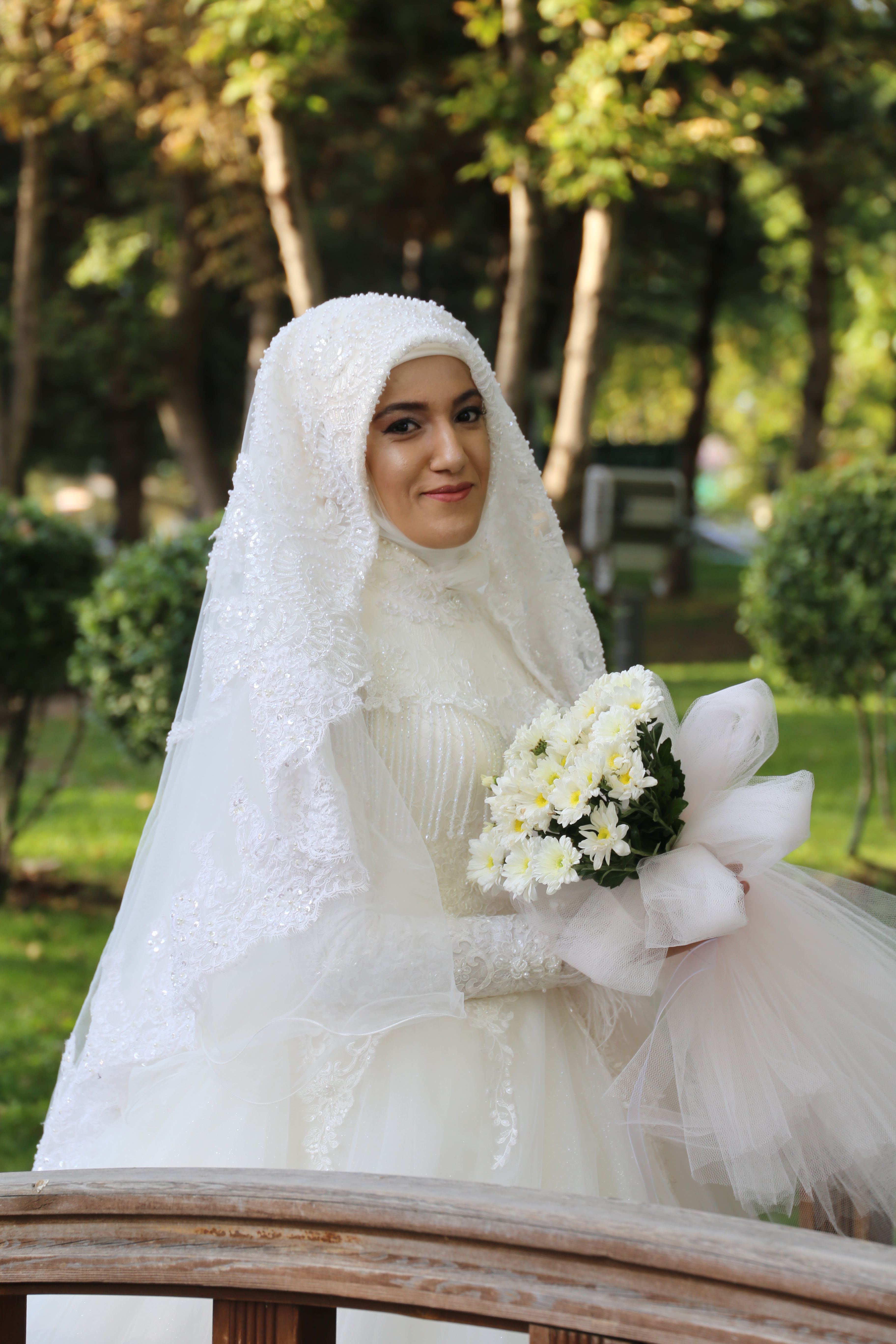 Woman in White Wedding Dress Holding Bouquet of Flowers · Free Stock Photo