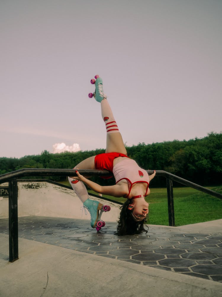 Woman Doing Tricks On Roller Skates On Handrail