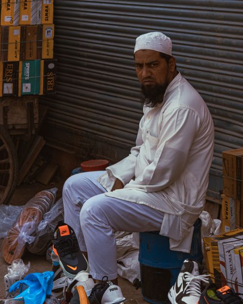 Free Portrait of a street vendor in New Delhi, showcasing his wares amidst urban hustle. Stock Photo