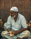 Bearded Man Sitting Cross Legged on Ground